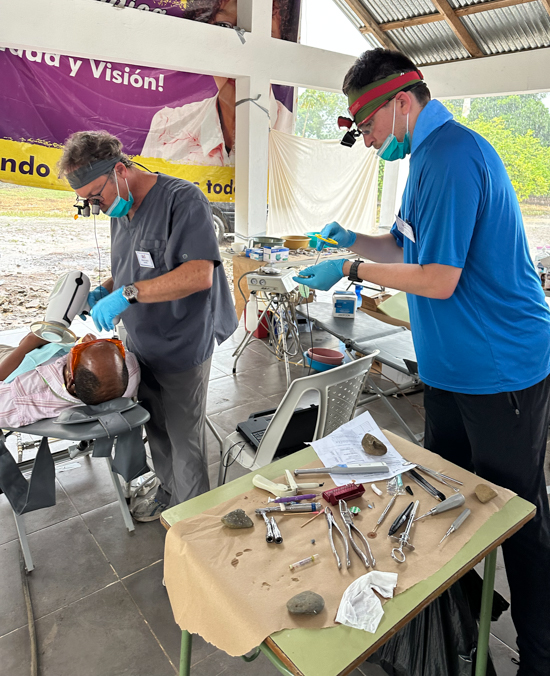 Don Czaplicki and a Creighton dental student care for a patient at the ILAC clinic.