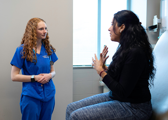 Creighton nurse interacts with a patient.