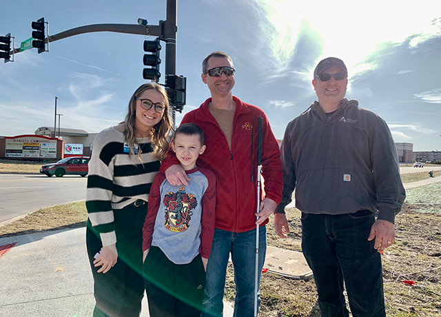 Image of Rachael Barnette with Ben and Brad Smith at the crosswalk.