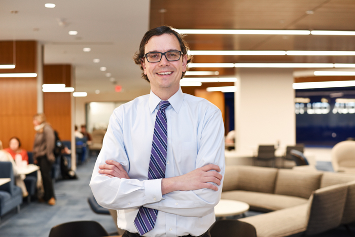 Hunter Allen, BSBA'14, pictured in the Harper Center, home of the Heider College of Business.