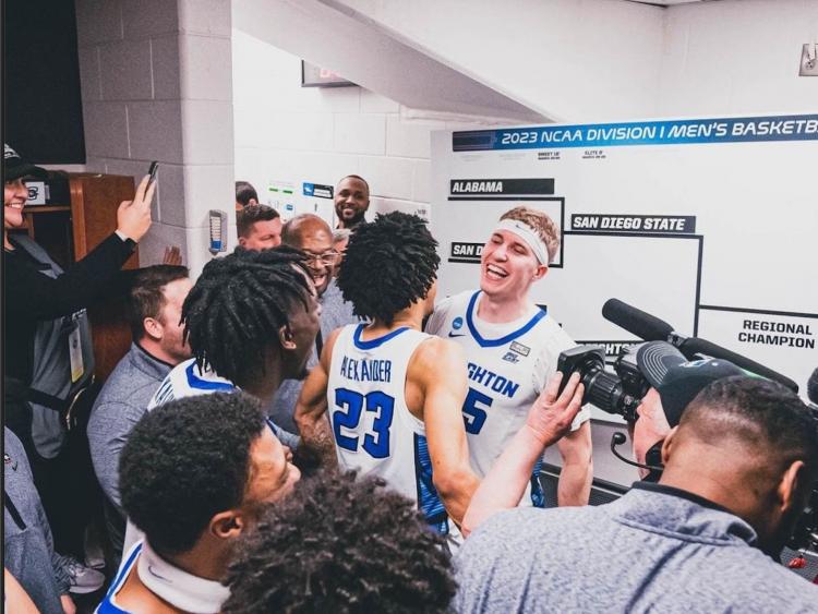 A team celebrates a big win together in the locker room