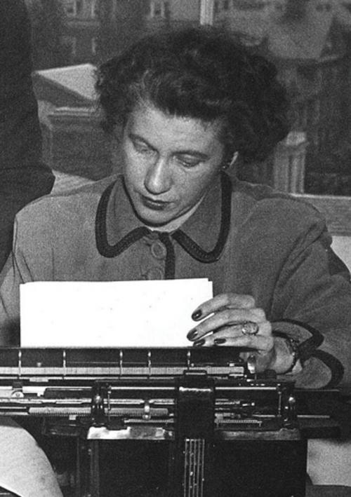 Mary Ellen Leary Sherry looks at a typewriter in 1946