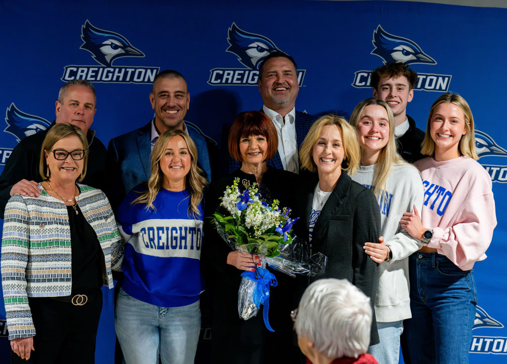 Patty Galas joins her family for a photograph at a March 1 Creighton men's basketball luncheon.