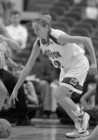 Jenny (Burns) Vickers dribbles the basketball during a game in 2002