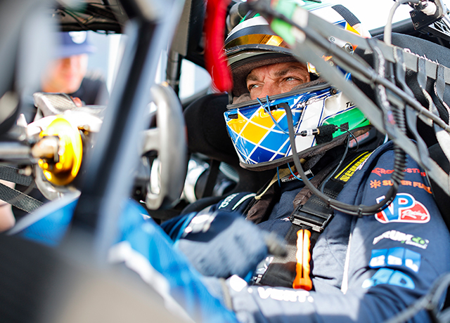 Todd Coleman behind the wheel of a race car.