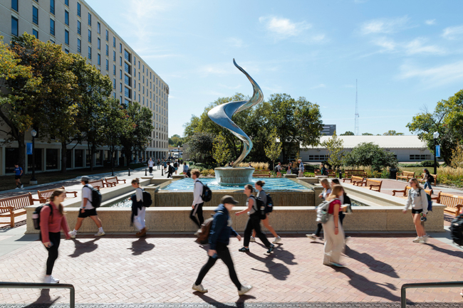 Students walk by the fountain.