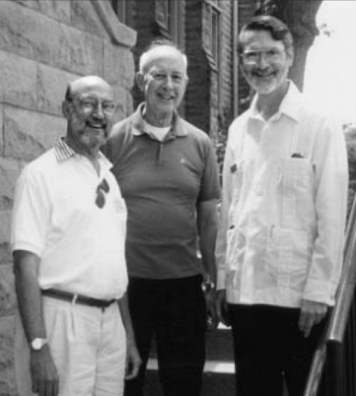 Three men stand next to each other for a photo