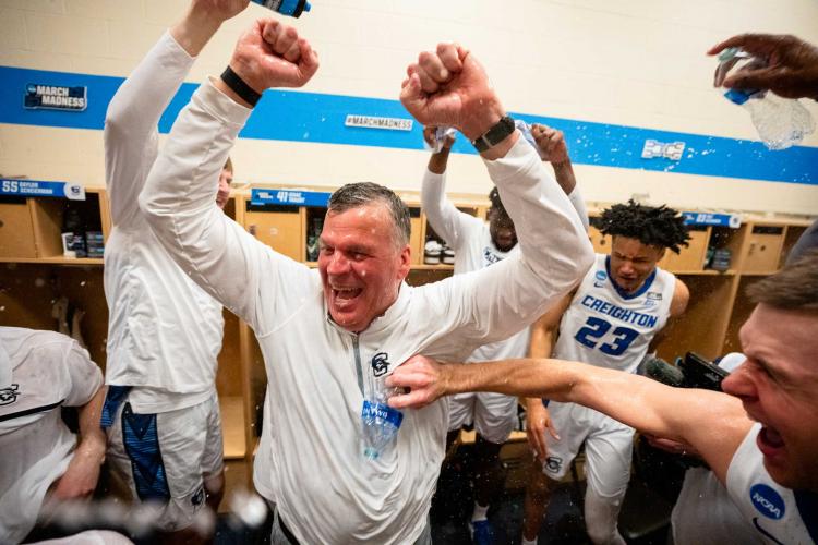 A team celebrates a big win together in the locker room