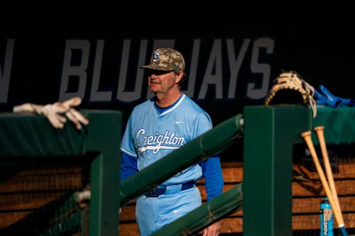 A baseball coach walks through the dugout