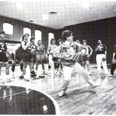 Mary coaching the team in the old gym.