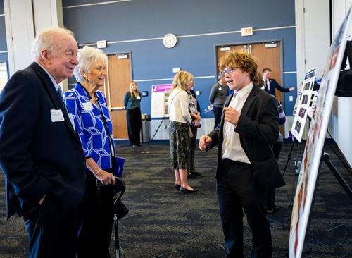 The Ferlics engaging with a student poster presentation
