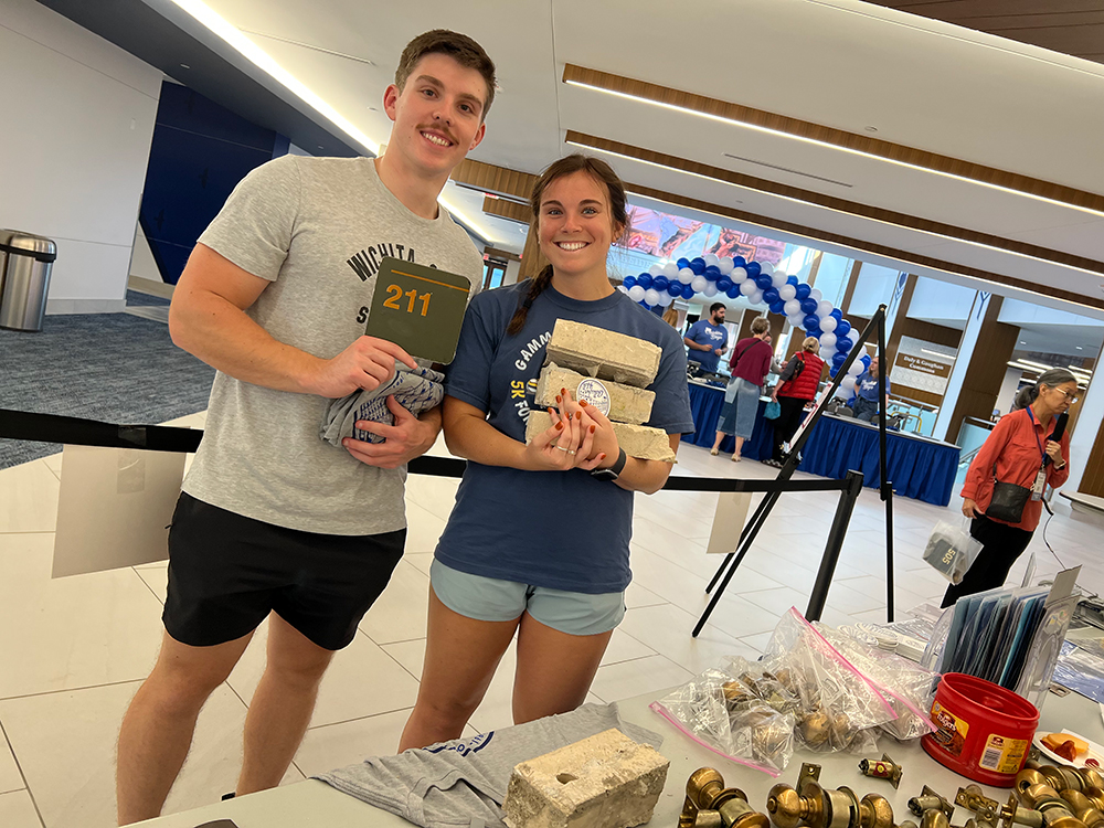 Students hold up room numbers at Gallagher Garage Sale