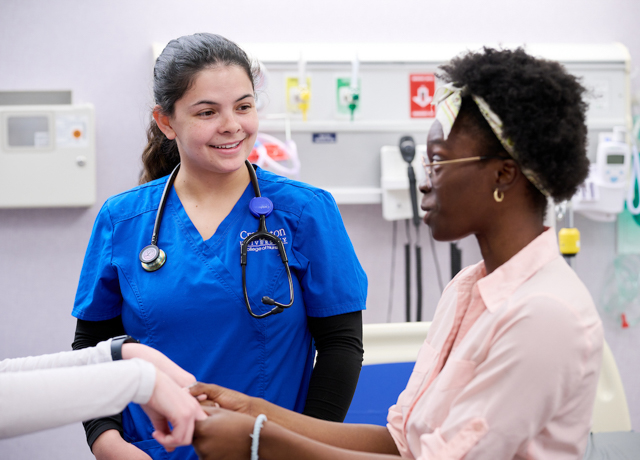 Image of student nurse with patient.