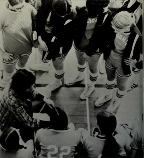 An image of the women's team in a huddle during a game.