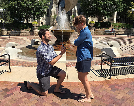 A Creighton alumnus proposes to his girlfriend in front of St. John's Fountain.