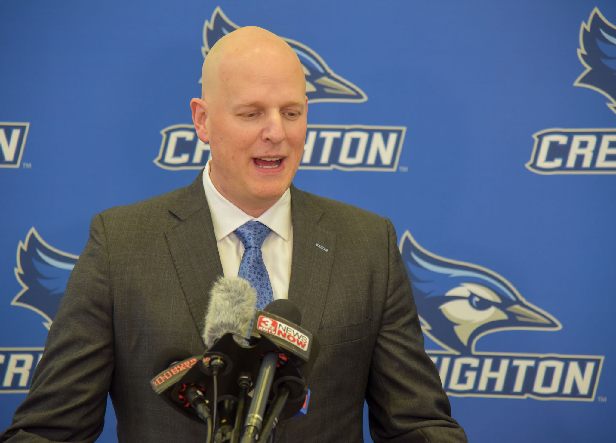 A basketball coach speaks to reporters