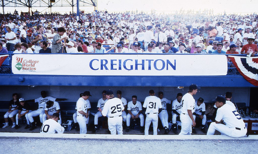 1991 Creighton baseball team at the CWS. Players in the dugout. Crowds in the stands.