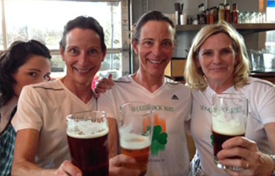 Three women toast and smile together
