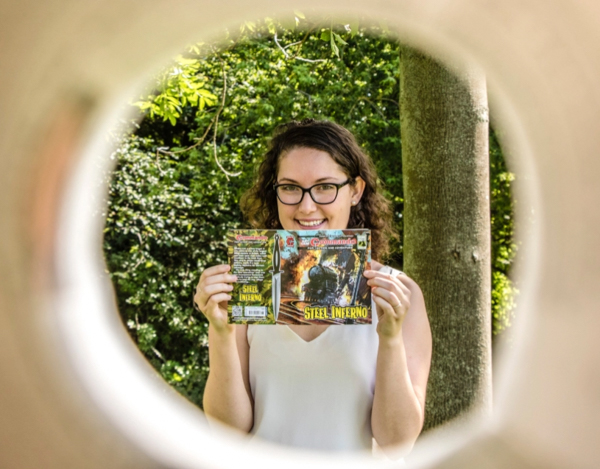 Austin holding Steel Inferno, one of the Commando comics she wrote.