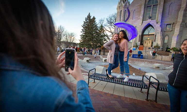 Students pose in front of the Fountain at the Celebration of Light ceremony.