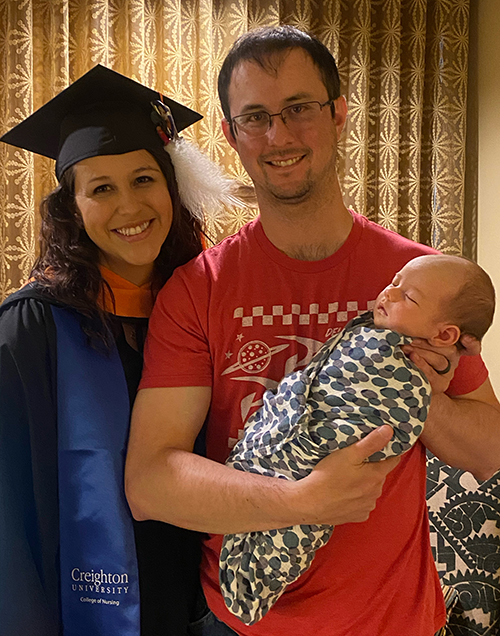Kristen Weston and Greg Campbell with their newborn son, Samuel Campbell, at 2021 commencement.