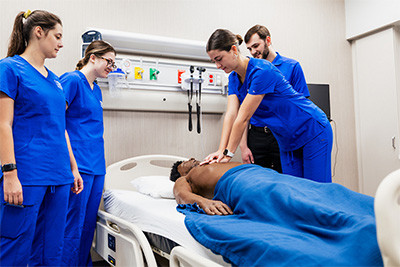 Nuring students working with manikin