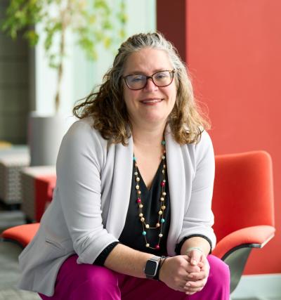 A woman smiles while seated