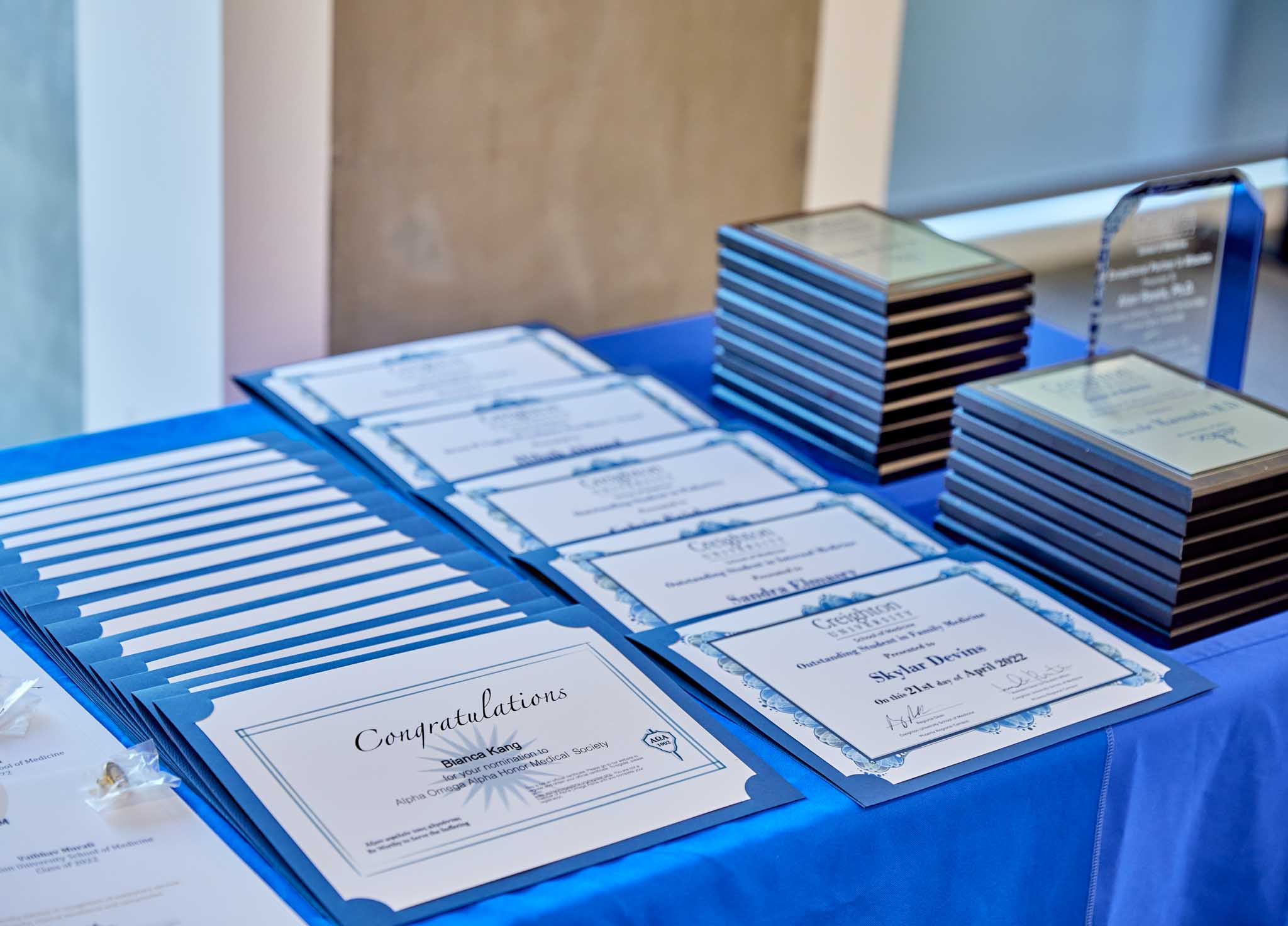 Plaques and award certificates are laid out on a table