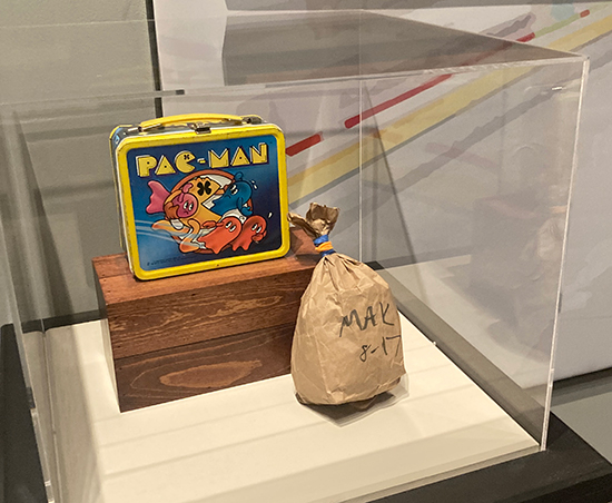 The Pacman lunchbox and the brown bag.