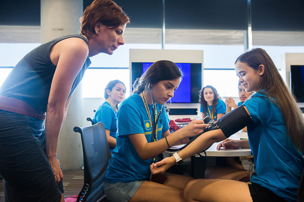 Julia Jackman, right, gets her blood pressure taken at the 2016 Summer Health Institute camp.