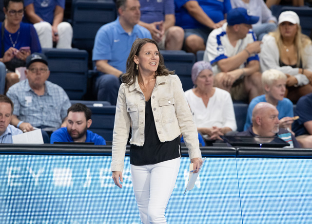 Creighton coach Kirsten Bernthal Booth stands on the sideline during a match.