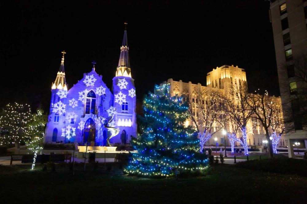 A church and an administrative building illuminated for Christmas