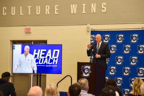 A coach speaks at a press conference