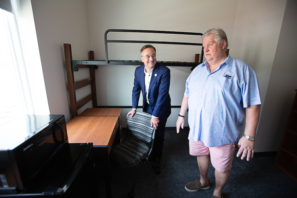 Creighton President Fr. Daniel S. Hendrickson with Lee Graves on a tour of Graves Hall.