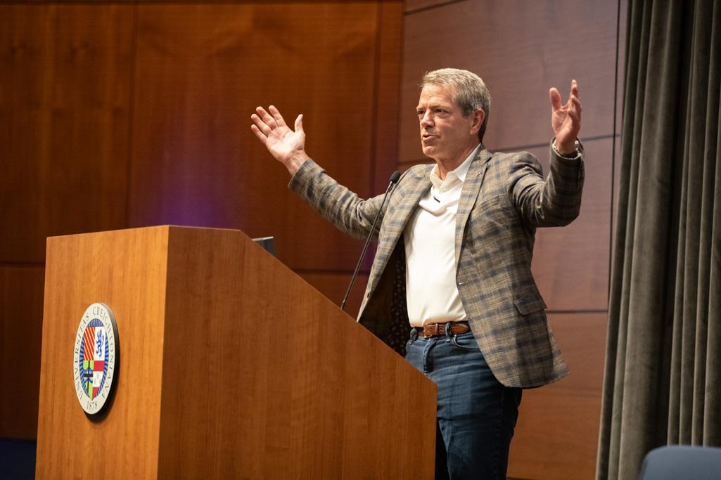 Nebraska Gov. Jim Pillen raises his arms while he speaks