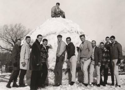 A photo from 1965 of Creighton students standing in front of a massive snowball