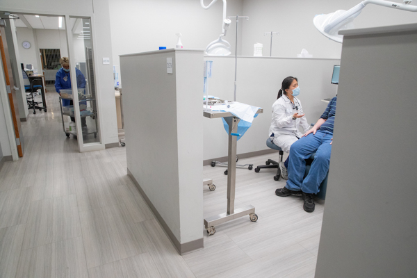 A student speaks with a patient.