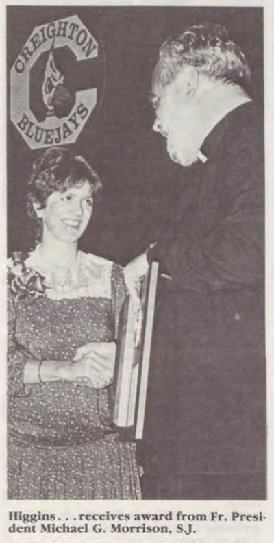 Mary Higgins receiving award from Fr. Morrison