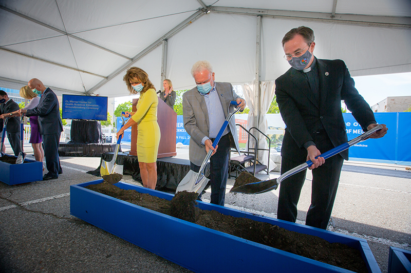 From left: Rachel Werner, CL Werner and Father Hendrickson at the ceremonial groundbreaking for the Werner Center.