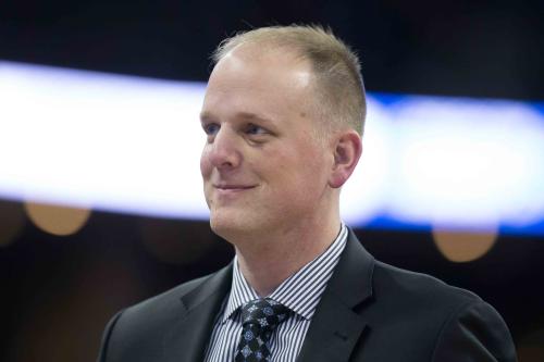 A coach smiles at a game