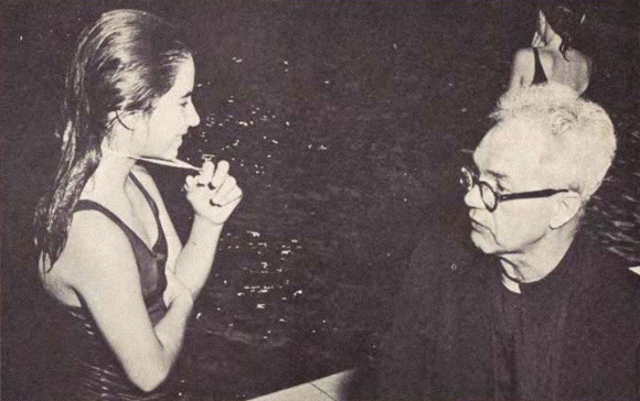 Fr. Hasbrouck speaks with a young swimmer.