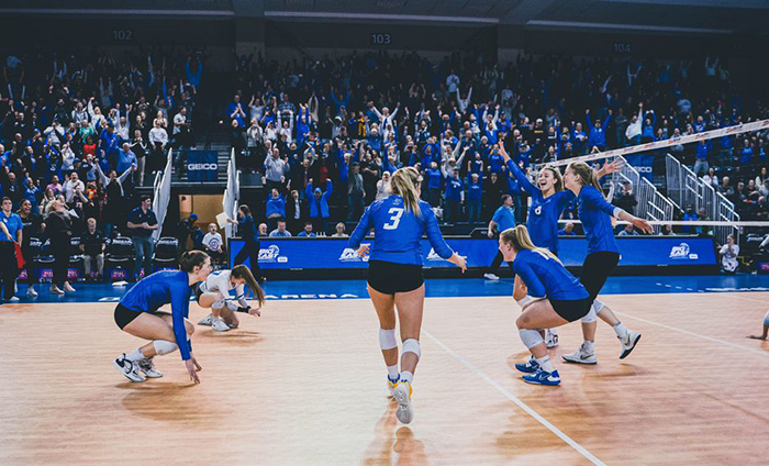 The Creighton volleyball team celebrates after a win.