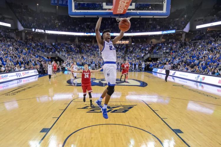 A player dunks a basketball