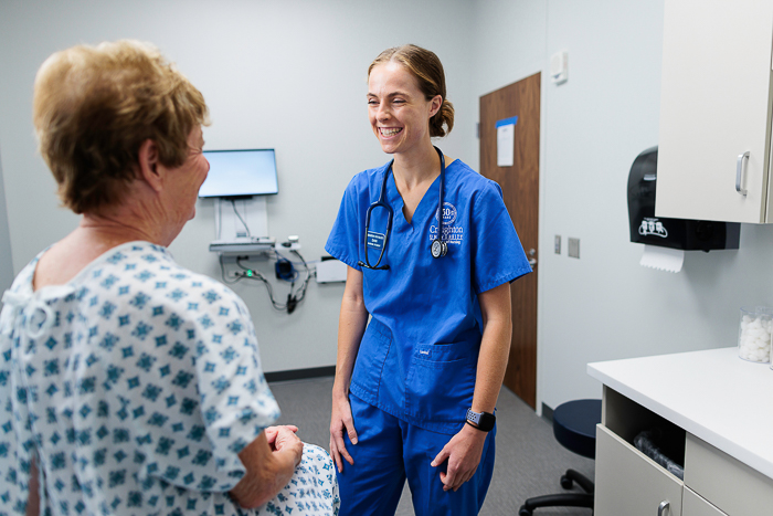 Creighton nurse interacts with a patient. Creighton nurse interacts with a patient.