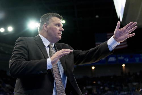 A coach gestures from the sideline