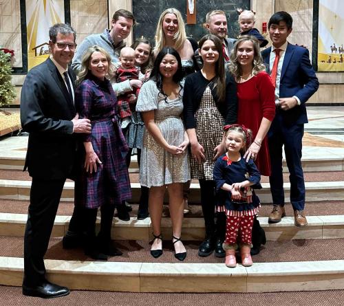 Ahern Love Story family church A family poses together on stairs for a photo