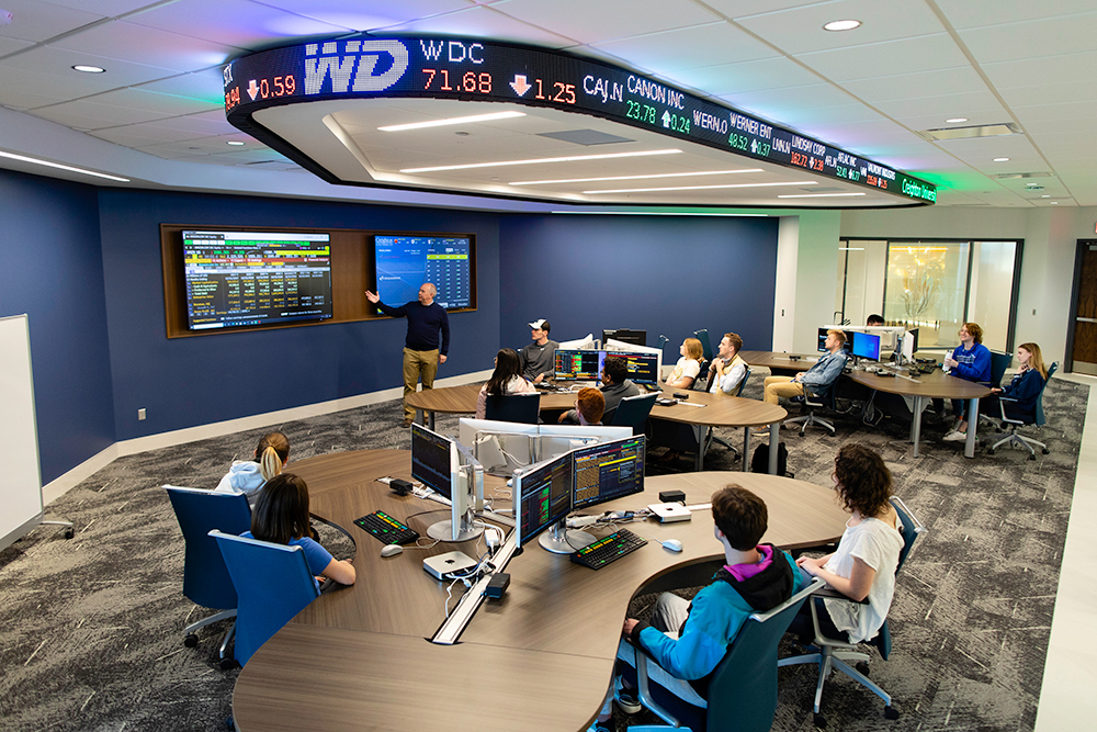 A professor instructs students in a Harper Center classroom