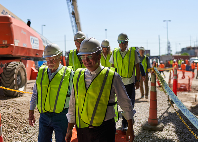 CL Werner and Fr. Hendrickson walking into the Werner Center construction site.