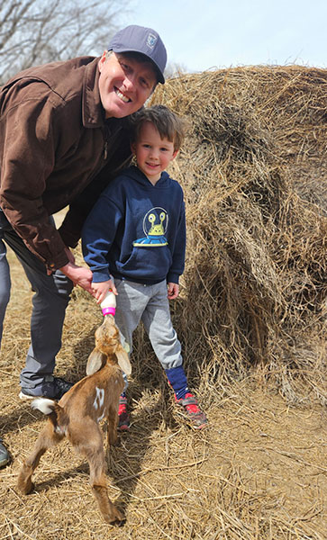Stewart and son on Iowa farm
