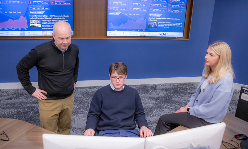 Will Kaatz at computer with faculty